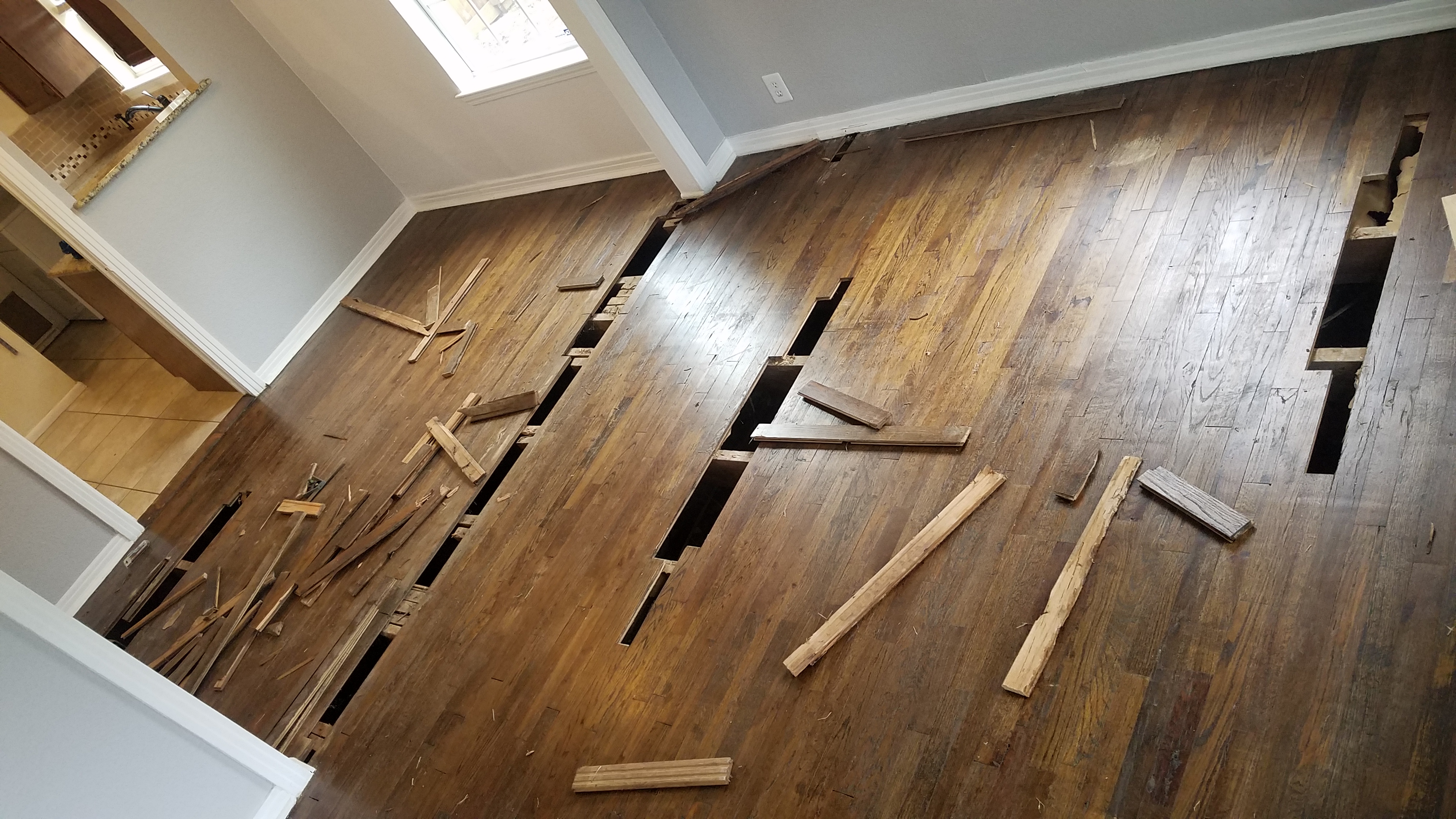Before: floor damage — restoration project